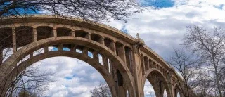 Historic arched concrete bridge in Allentown Pennsylvania framed by bare winter trees