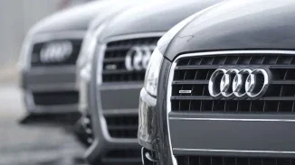 Row of Audi quattro vehicles with chrome four-ring logos representing auto defect product liability claims