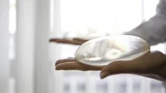 Silicone breast implants held in hands representing defective medical device product liability litigation