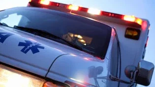 Ambulance with emergency lights activated responding to accident scene in personal injury case