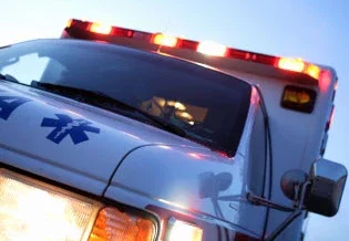 Ambulance with emergency lights activated responding to accident scene in personal injury case