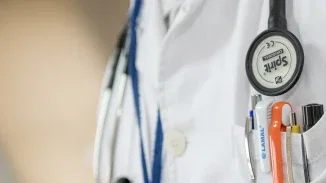 Close-up of physician in white coat with stethoscope representing medical negligence accountability