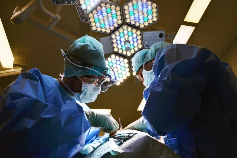 Two surgeons performing operation under bright lights representing surgical malpractice and patient harm