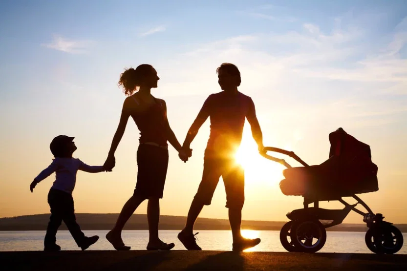 Family silhouette walking at sunset with stroller representing the future clients fight to protect
