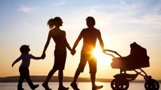 Family silhouette walking at sunset with stroller representing the future clients fight to protect