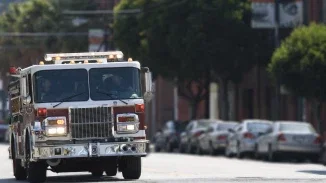 Fire truck with emergency lights on responding to incident representing first responder accident claims