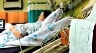 Pregnant woman connected to fetal monitoring equipment in hospital labor and delivery room