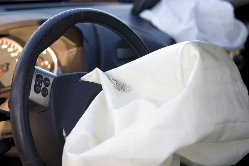 Deployed airbags inside vehicle cabin representing defective auto safety system and personal injury lawsuit