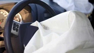 Deployed airbags inside vehicle cabin representing defective auto safety system and personal injury lawsuit
