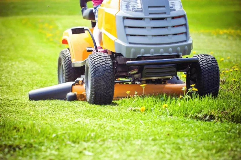 Riding lawn mower cutting grass representing dangerous equipment personal injury accident case