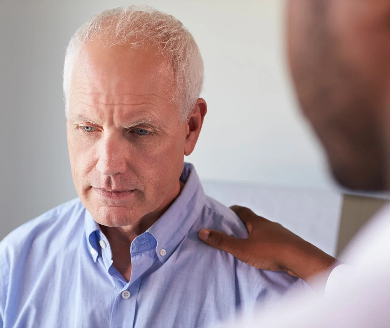 Man receiving diagnosis from doctor