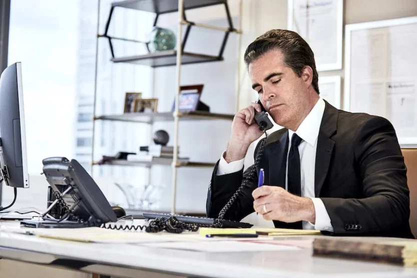 Matt Casey, Philadelphia medical malpractice attorney, on phone taking notes at office desk