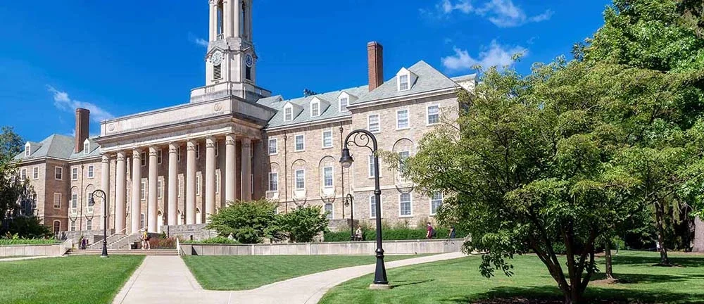 Penn State Old Main building and manicured lawn representing Pennsylvania university campus legal matters