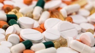 Assorted prescription medication tablets and capsules in multiple colors representing defective drug personal injury claims