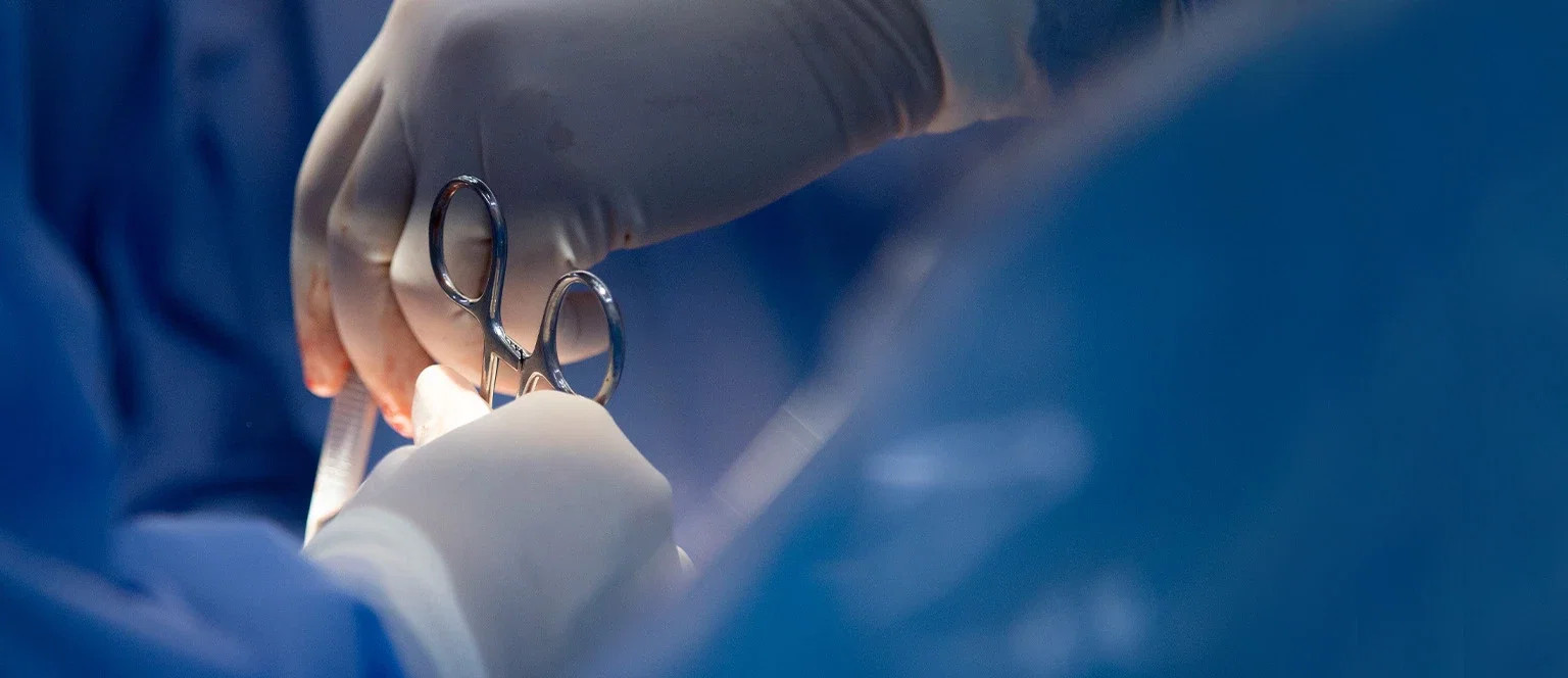 Close-up of gloved surgeons