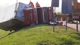 Overturned tractor-trailer being recovered at accident scene relevant to Pennsylvania trucking injury claims