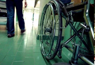 Empty wheelchair in hospital hallway representing serious personal injury resulting in long-term disability